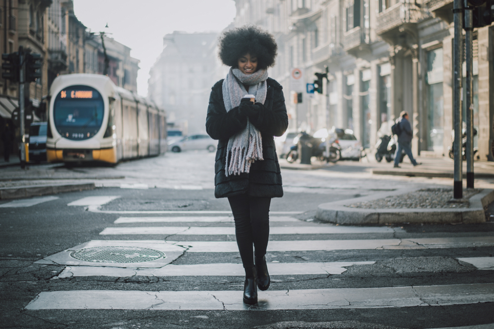 stylish woman in coat and scarf with coffee in San Francisco 