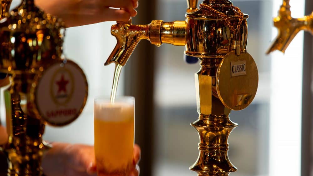 Pouring Sapporo Beer on tap