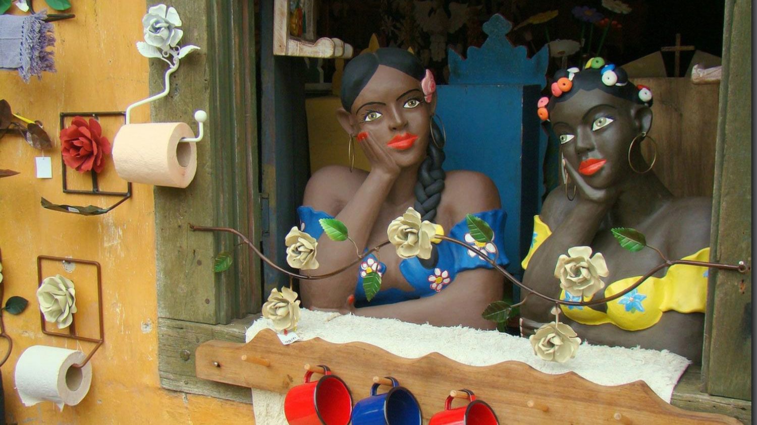 Sculptures of two women looking out a window in the arts village of Embu das Artes in Sao Paulo, Brazil