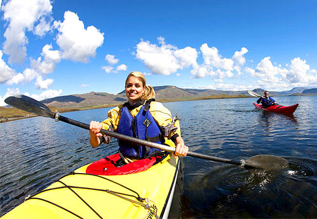 Couple kayaking in fjord in Reykjavik