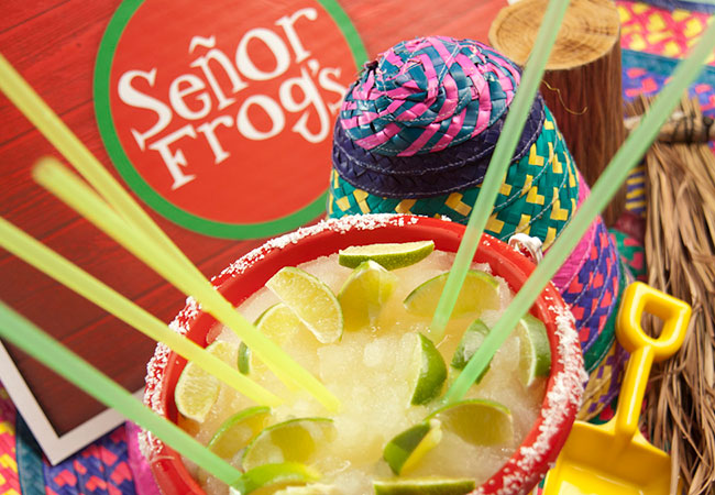 Large margarita on table with festive décor in Cancun