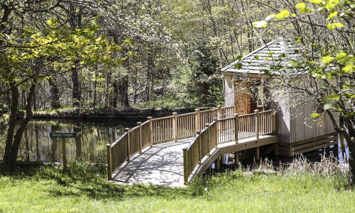 This is the lakeside Durga Temple at the Sivananda Yoga Ranch in Woodbourne, New York with a wooden hut to be at one with nature.