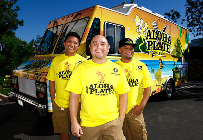 Crew from Aloha Plate stand in front of food truck in Honolulu