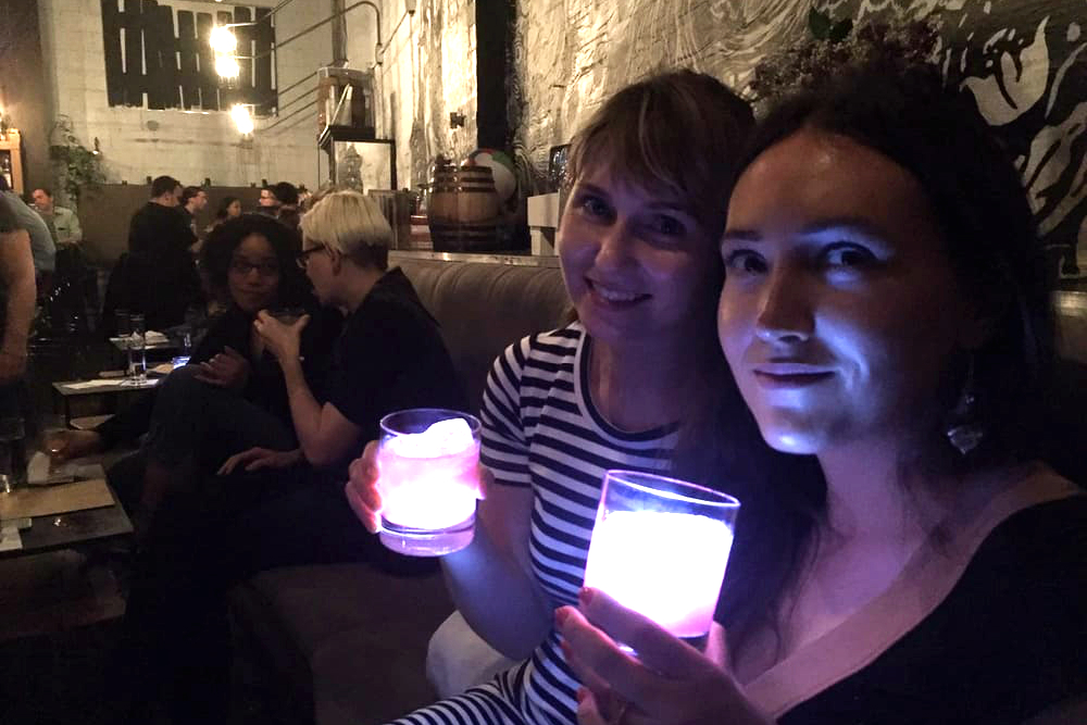 two girls in a bar with light-up drinks
