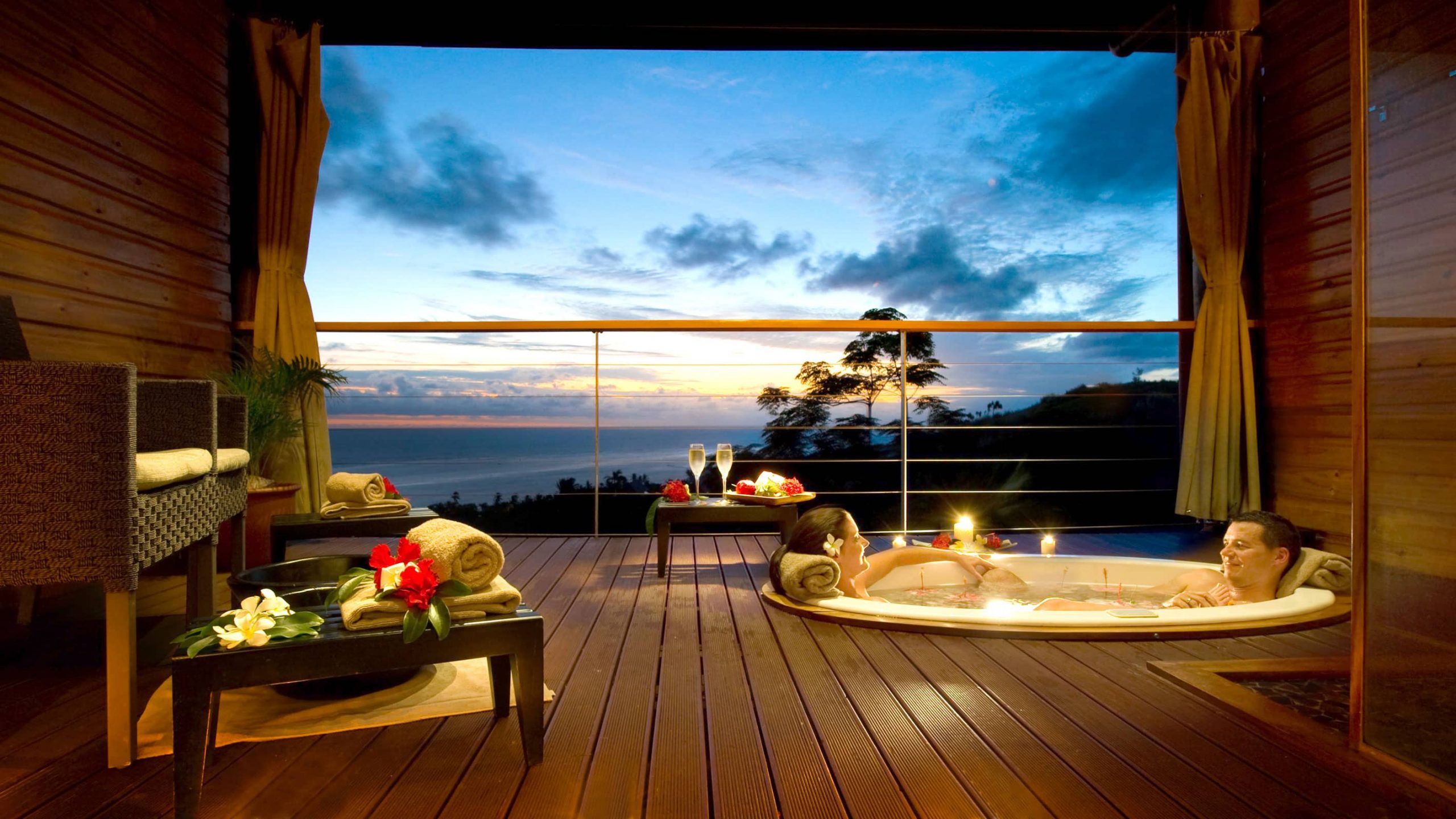 A couple enjoys the view from their suite.