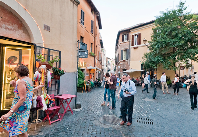 Tourists stroll through historic Trastevere on the way to dinner in Rome