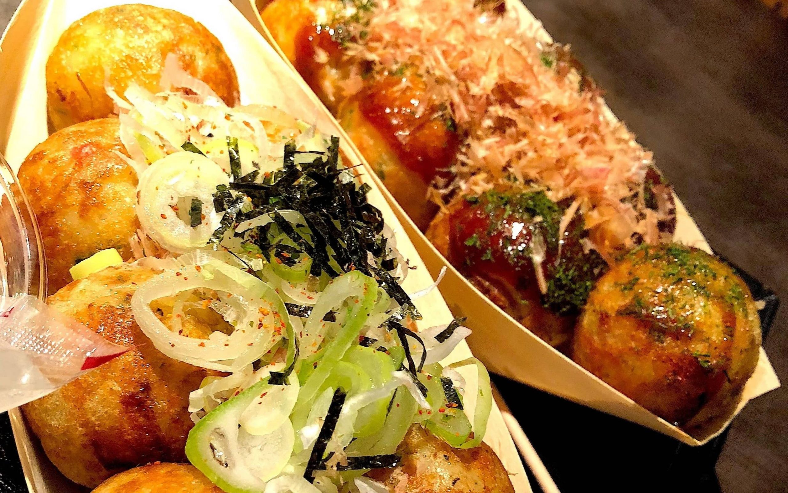 Takoyaki served in a boat shaped dish in two different ways