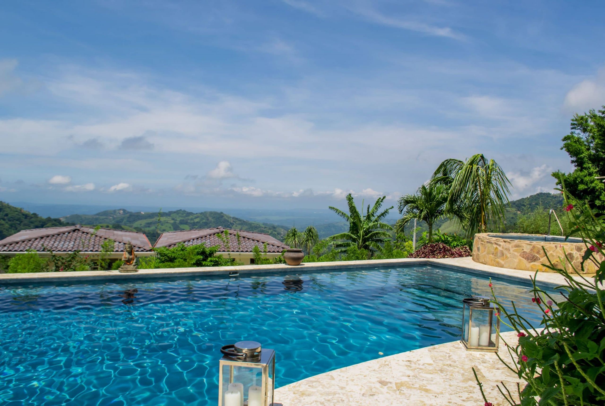 Outdoor pool with beautiful blue water and view of the Costa Rican canopy and ocean horizon at The Retreat.