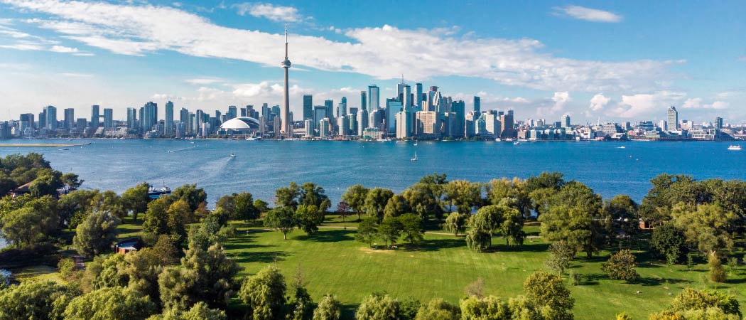 Bright and green views of the Toronto skyline across the lake