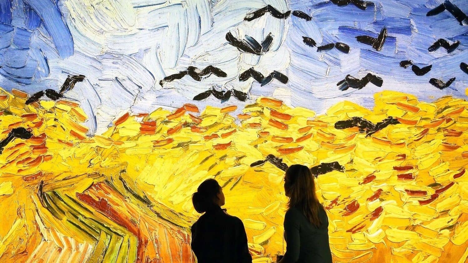 Two people enjoying the Meet Vincent Van Gogh exhibit in London