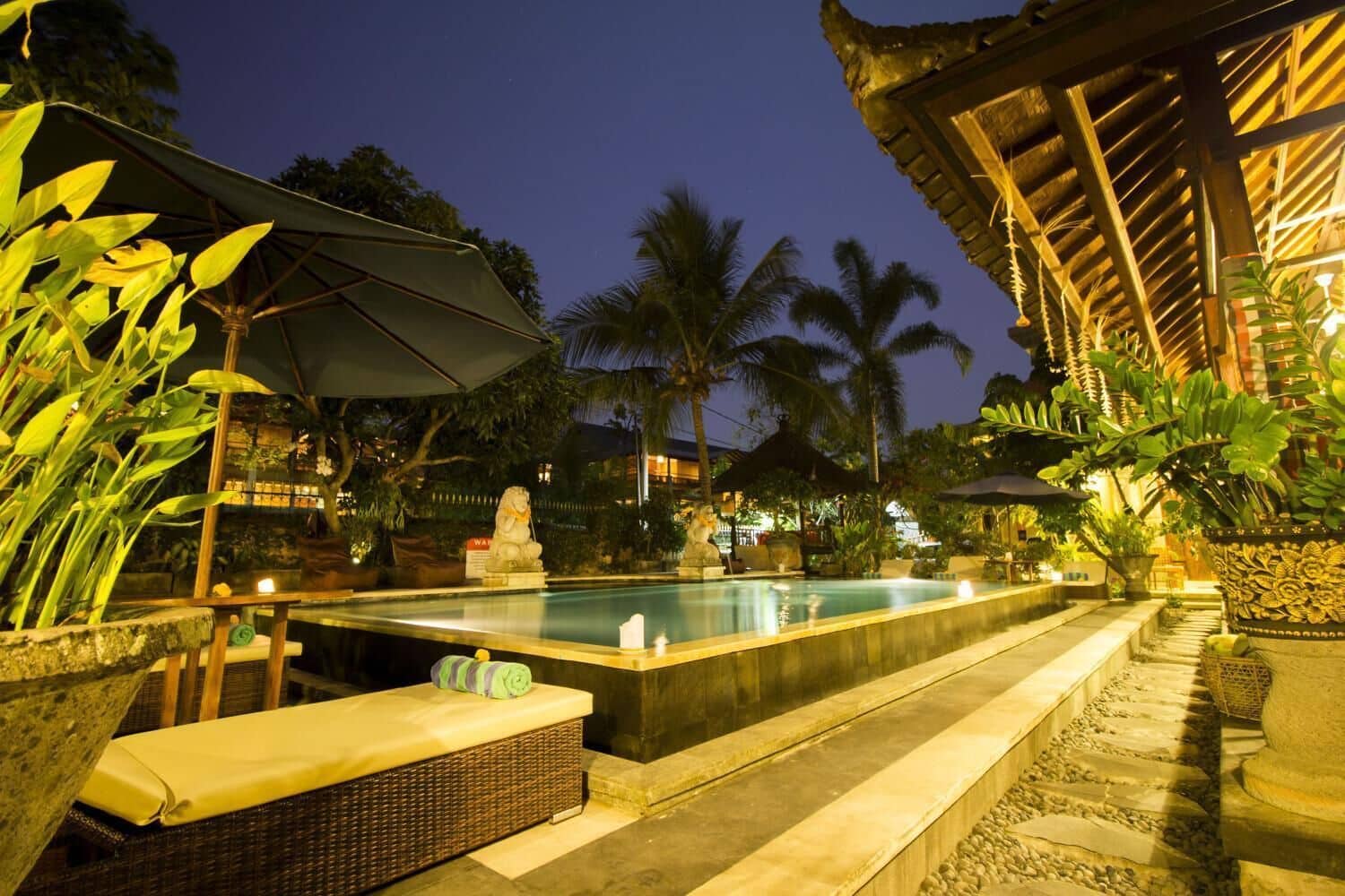 A night time at the Ubud Aura Retreat Center in Bali where guests can relax b y the pool and enjoy serenity away from their daily lives.