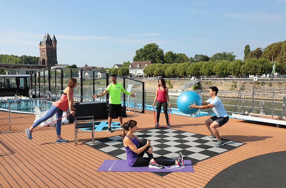 Cruise guests working out in the sundeck of AmaMora