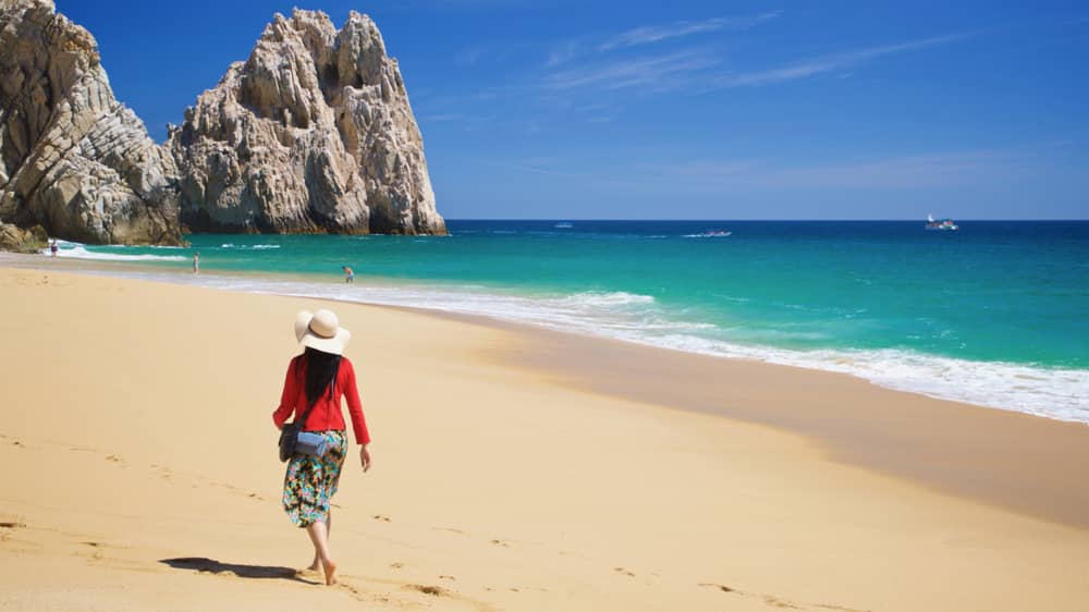 Woman walking on Divorce Beach in Los Cabos - Mexico