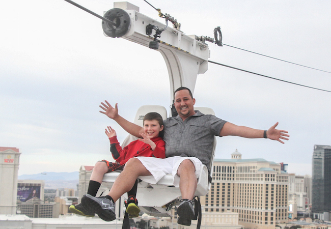 Father and son on zipline above Las Vegas Strip