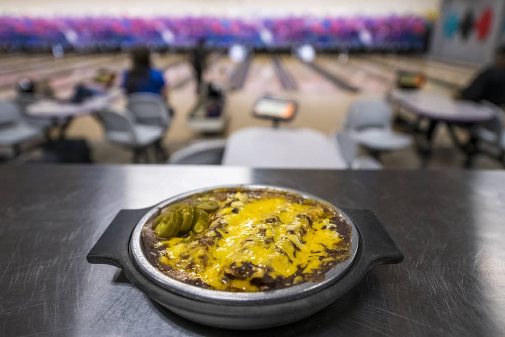 Dart Bowl Cafe's famous enchiladas are pictured in front of bowling lanes.