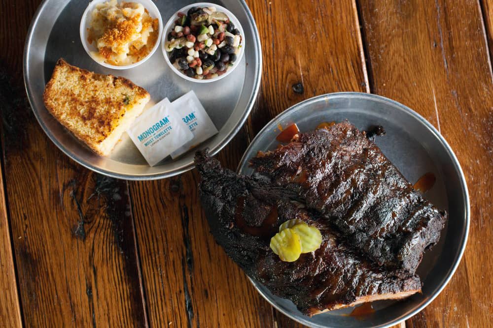 The hearty Rib Platter with cornbread, bean salad, and mac and cheese at Edley's Bar-B-Que—an awesome place to eat in Nashville