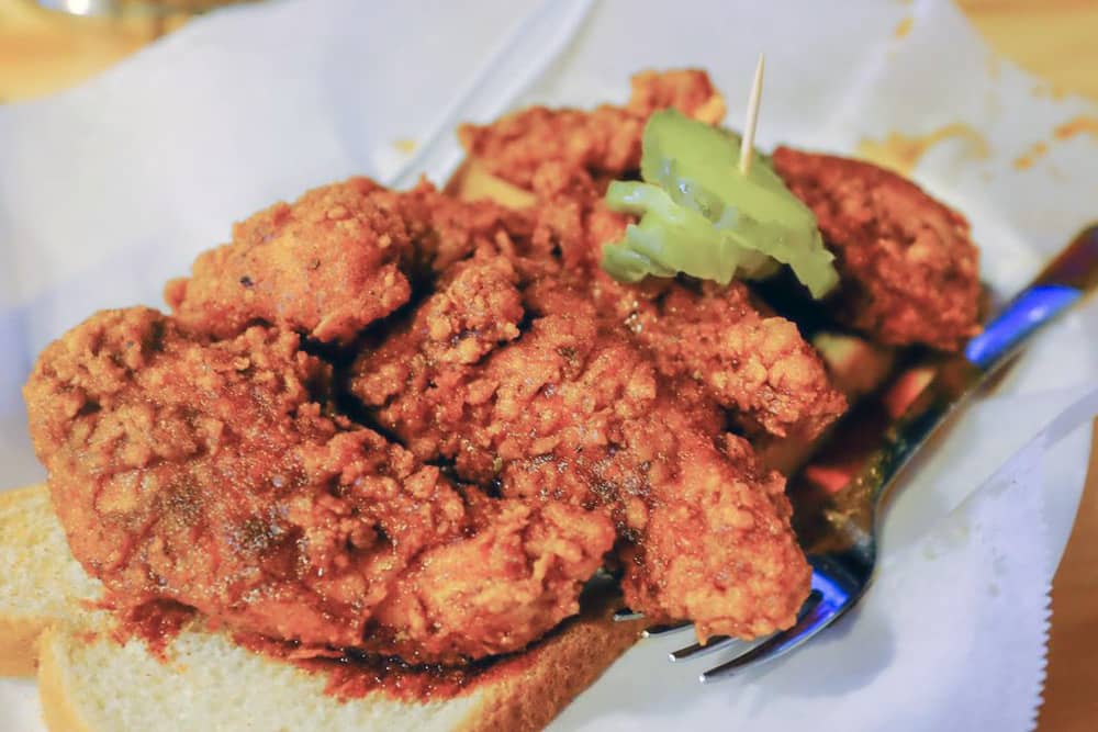 A spicy snack at Prince's Hot Chicken A plate of Nashville hot chicken at Prince's Hot Chicken—a fun food challenge for your bachelor party in Nashville