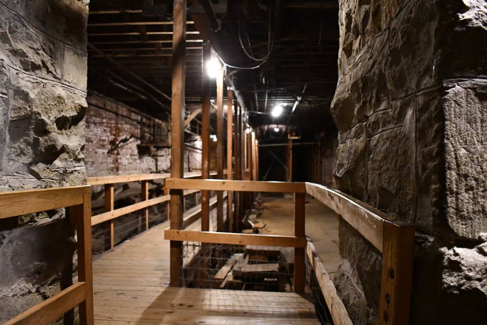 Wooden walkways through brick and stone corridors on the Underground Seattle tour, a great Seattle bachelor party experience