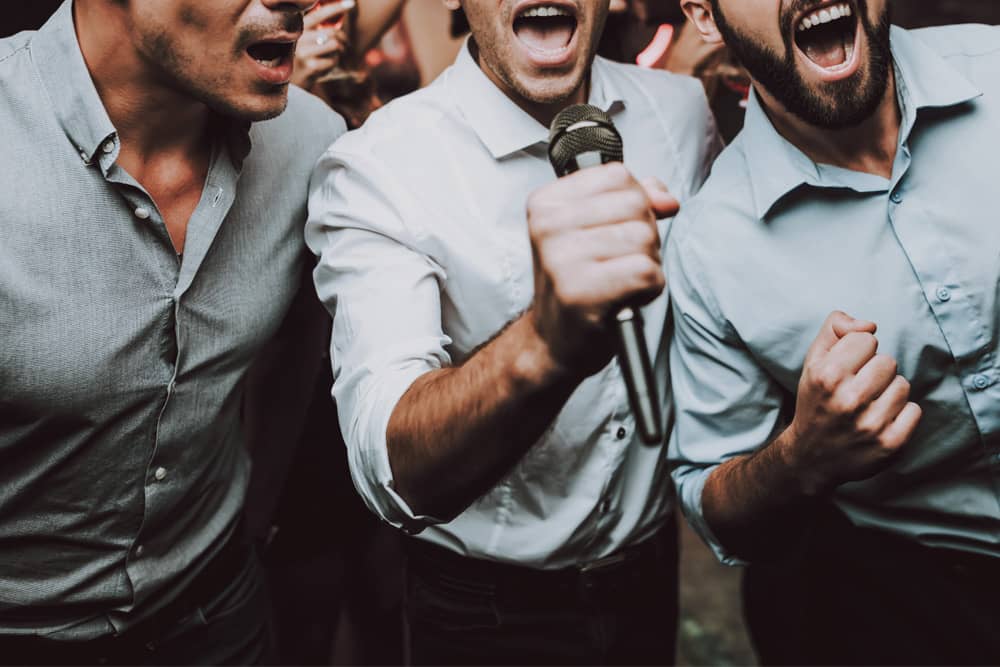 Good friends singing their hearts out at a karaoke bachelor party in Seattle