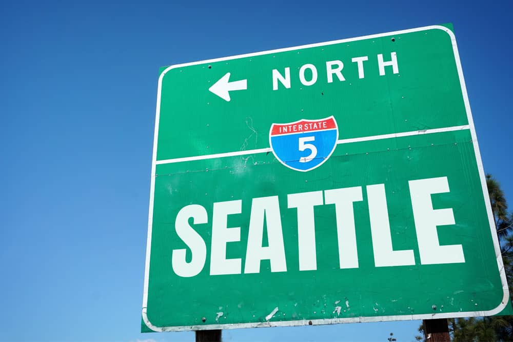 Green Interstate 5 sign pointing north to Seattle, welcoming travelers who are visiting Seattle for a bachelor party