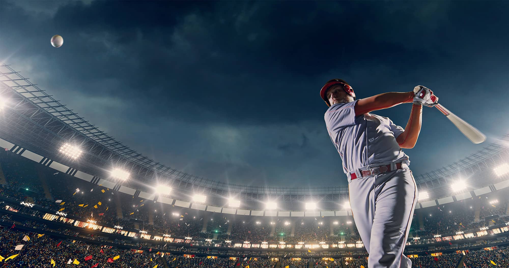 A male baseball player performs a dramatic play on the baseball stadium.