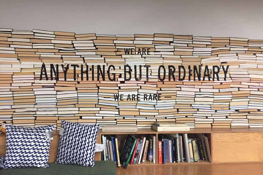 Books, pillows, and funky wallpaper at RARE, one of the top thrift stores in Anaheim.