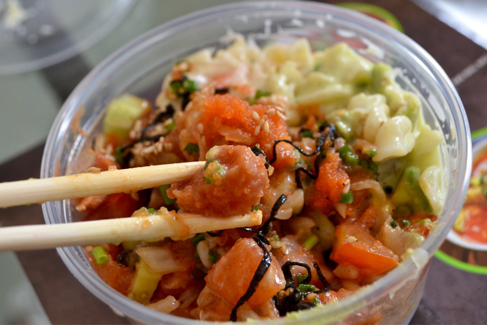 Bowl of poke in a take-out container, one of the best cheap eats in Honolulu