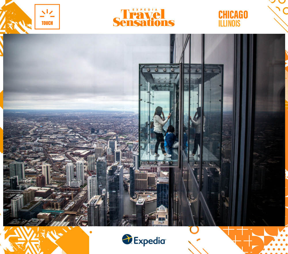 Young woman taking a selfie in the sky box at the top of the Willis Tower.