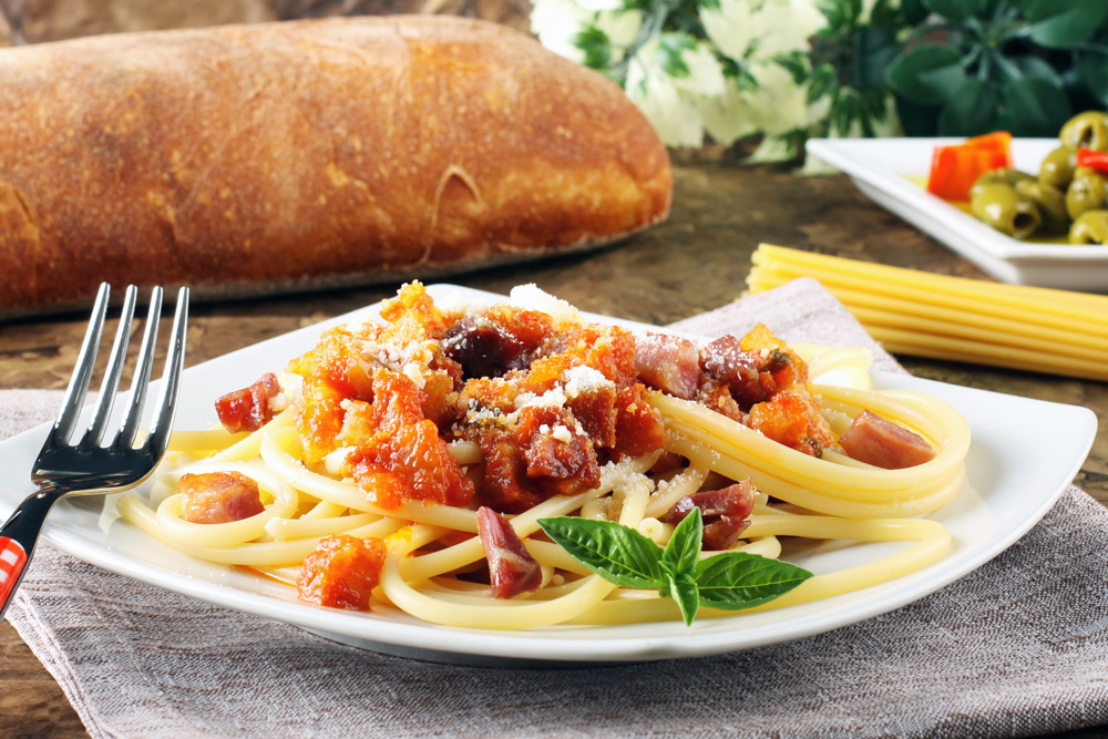 A plate of authentic pasta in Rome. Eating the traditional cuisine is a top travel tip in Rome. A plate of pasta in Rome. Eating the local cuisine is a top Rome travel tip.