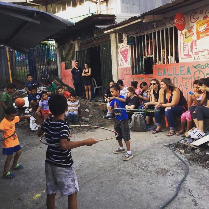 A group of children play with hula hoops and balls while outside of San Jose, Costa Rica.