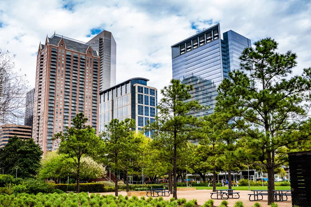 Scenic view of trees and picnic tables at Discovery Green Park, one of the best free places for families in Houston.