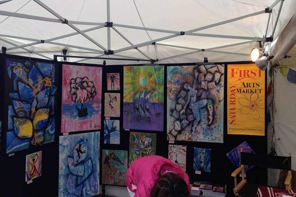 Bright, colorful art in a booth at First Saturday Art Market, a top free activity for kids in Houston