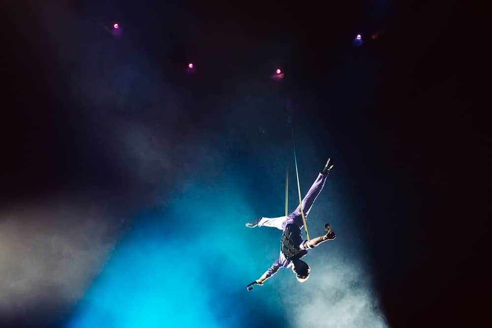 Acrobat hangs in the air at a circus show in Las Vegas, one of the top free activities to do with kids in the city.