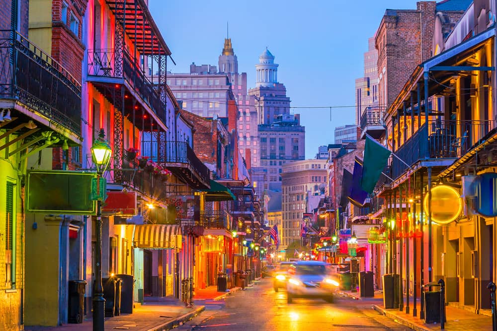 Street lanterns and colorful flags bring color to ornate balconies in the French Quarter during Mardi Gras