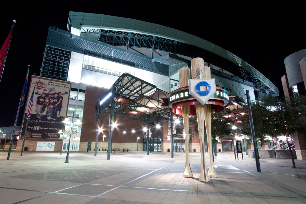 Chase Field in downtown Phoenix with a well lit courtyard after dark—one of the Arizona Spring Training locations.