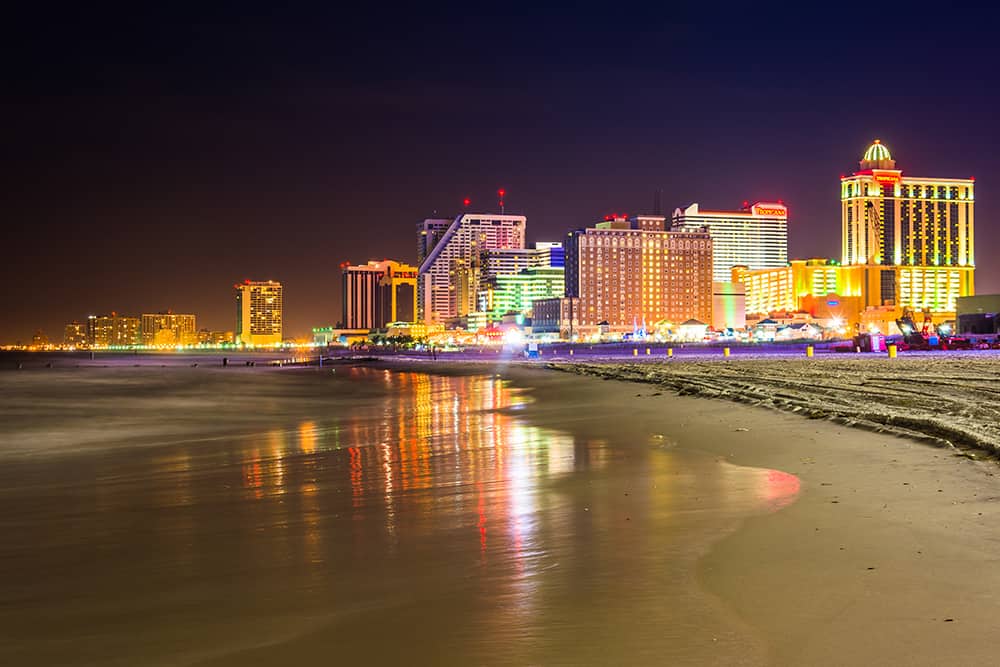 View of the Atlantic City skyline lit up at night, which is a great romantic day trip from NYC