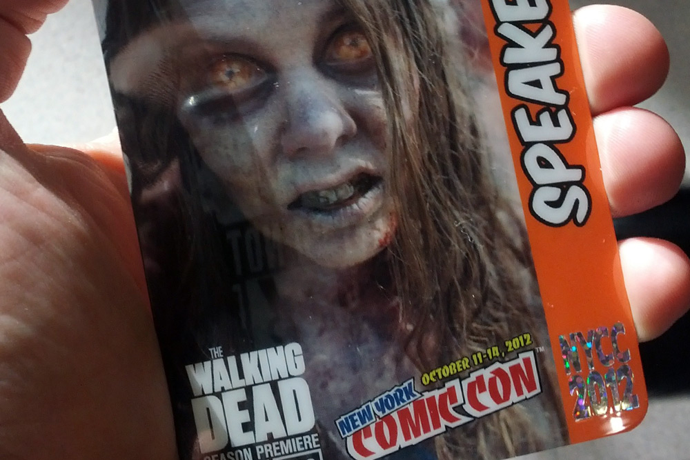 Closeup of a New York Comic Con badge from 2012 with a zombie from "The Walking Dead" on the front.