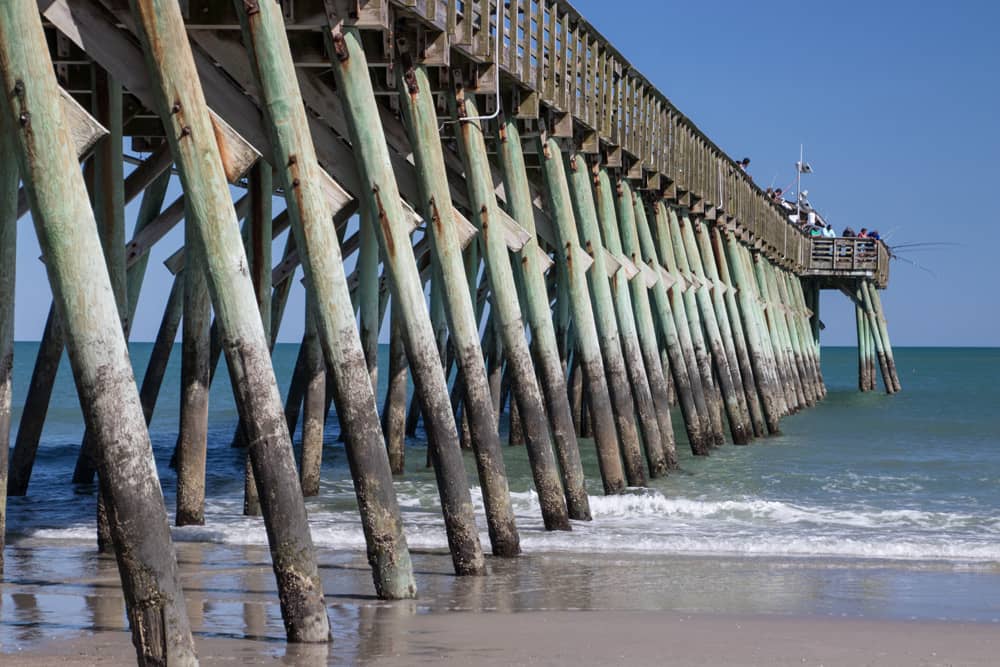 Myrtle State Park, which one of the top activities you can check out during the Carolina Country Music Fest Close up of wooden pier at Myrtle State Park, which you can visit during the Carolina Country Music Festival