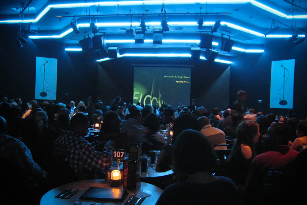 Guests at Tempe Improv waiting for the show to start under blue neon lights on their romantic day trip from Phoenix.