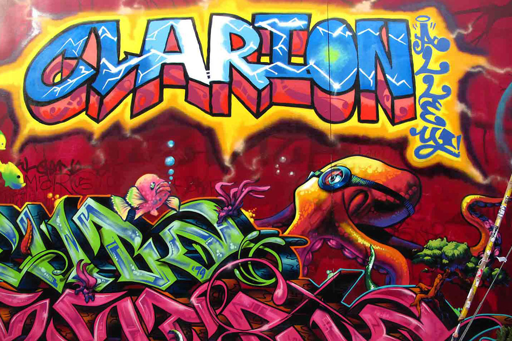 A colorful mural that reads "Clarion" with an octopus cartoon and graffiti in Clarion Alley, famous for its street art.