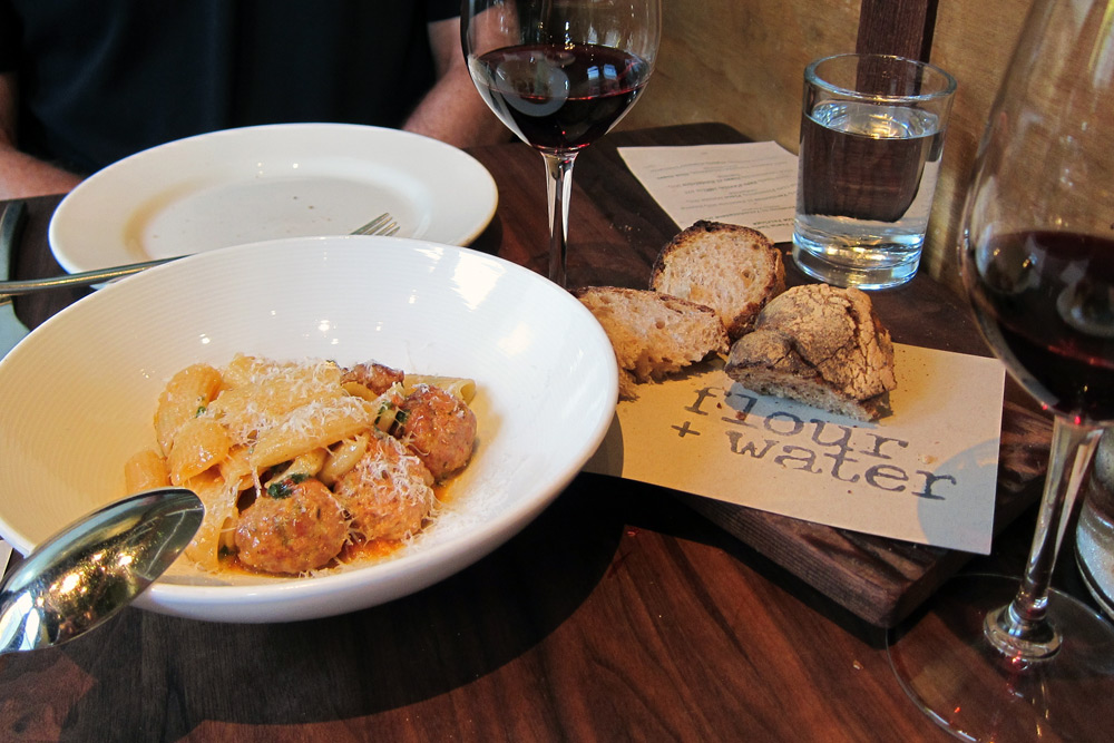 Handmade pasta and meatballs served with bread and red wine at Flour + Water is a delicious SF date idea without reservations.