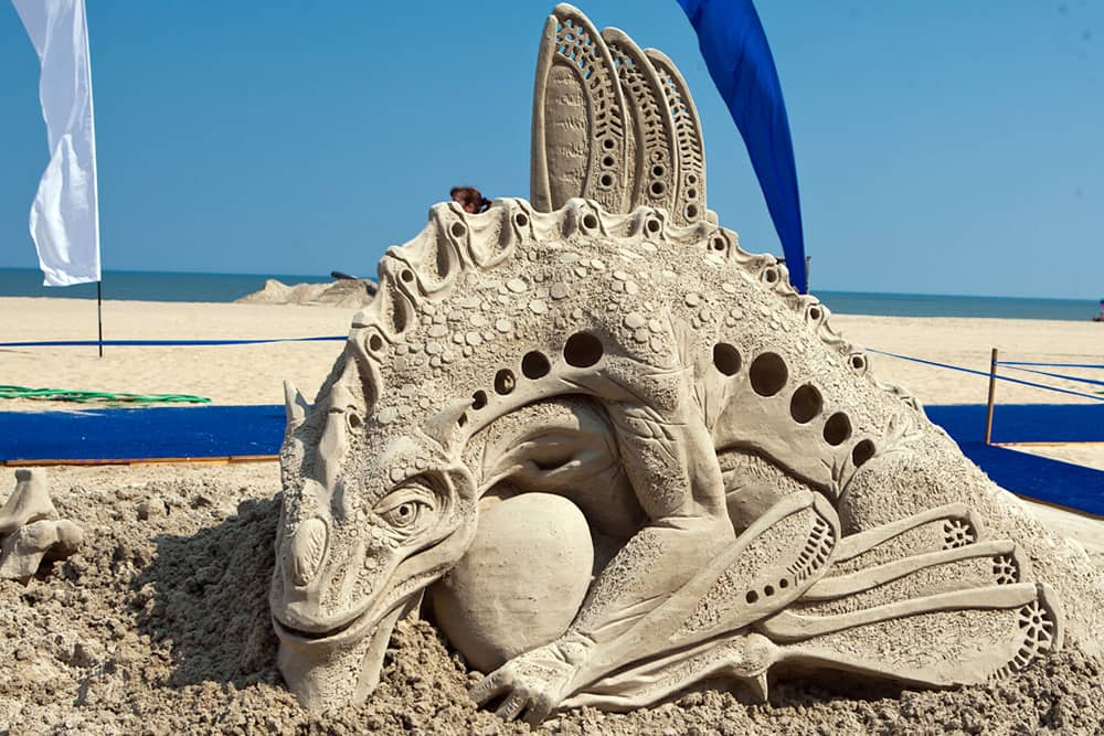 Intricate dragon sand sculpture on the beach at the Virginia Beach Neptune Festival.