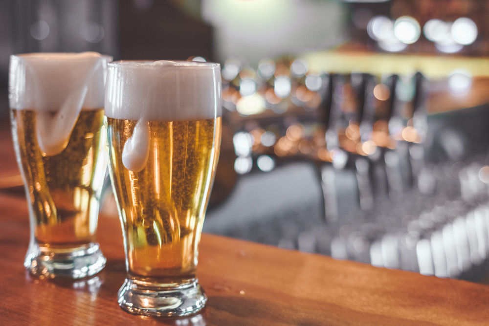 Two beers at a bar during a Portland bachelor party