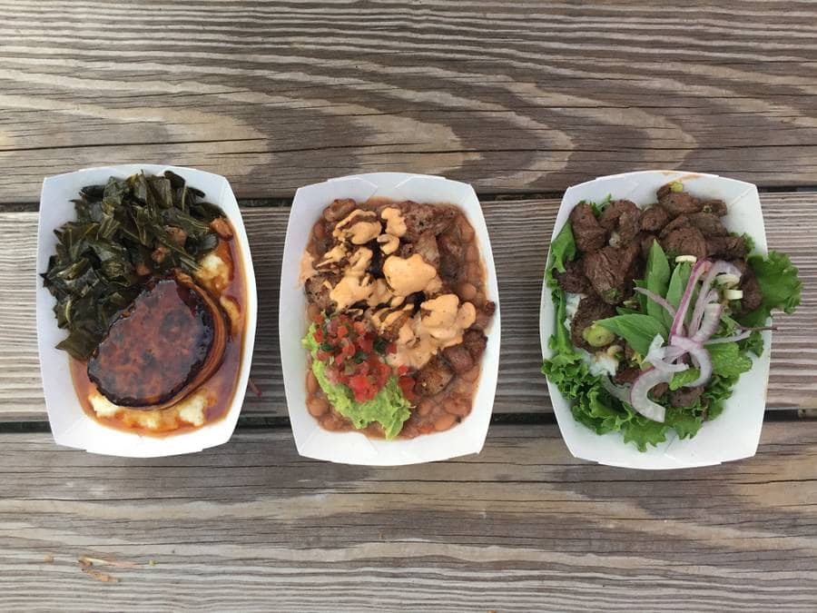 An overhead shot of three dishes, with meat, collard greens, and beans, from Three Little Pigs food truck.