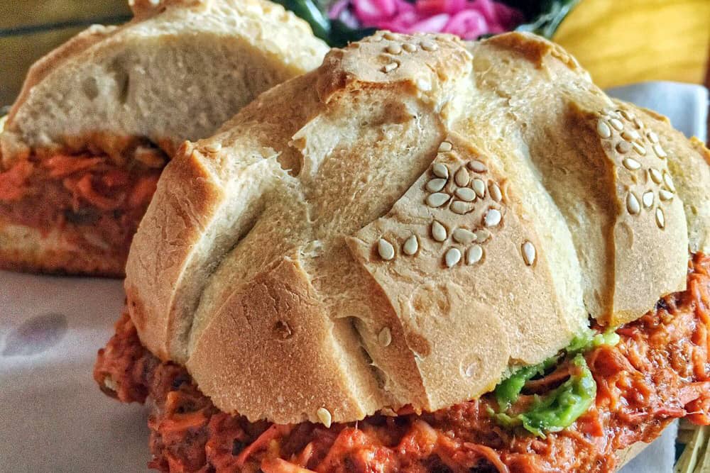 A hearty Torta de Cochinita Pibil—a delicious sandwich to eat in Cancun