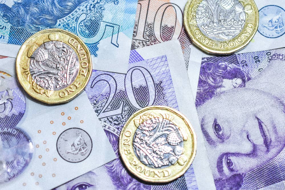 A close up of pence and pound notes, the currency they use in London. A close up of pence and pound notes, understanding currency is a London travel tip.