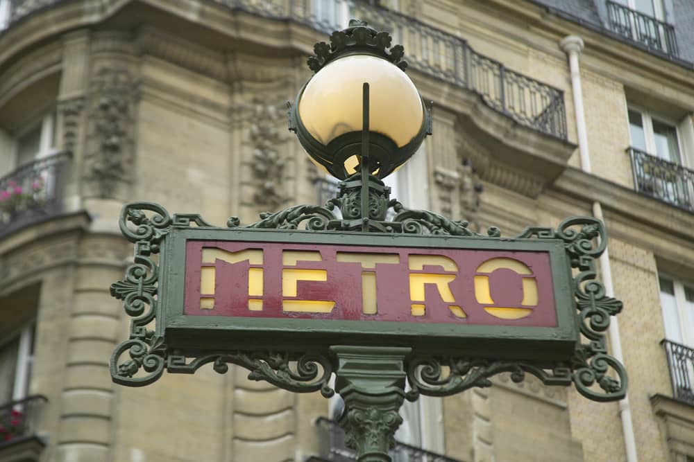 A red and green old-fashioned metro sign in Paris. Travel tip: public transportation in Paris is fantastic.