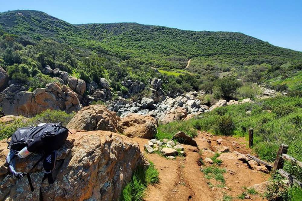 Hiking gear beside the trail at Los Peñasquitos Canyon Preserve—a great San Diego bachelor party activity