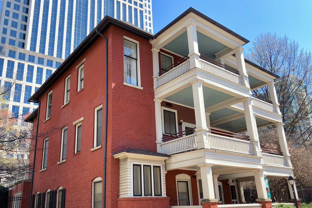 Atlanta is known for history at Margaret Mitchell's historic house. The historic home of writer Margaret Mitchell, who wrote "Gone with the Wind." A three-story red brick house with white columns and balconies.