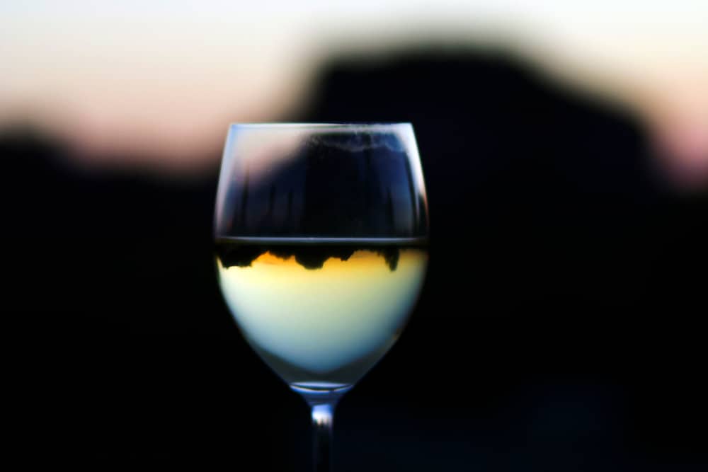 Reflection of the arizona sunset in a glass of white wine